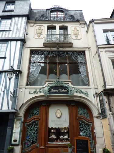 a building with a door with a clock on it at LA CHAUMIERE in Saint-Léger-de-Rotes