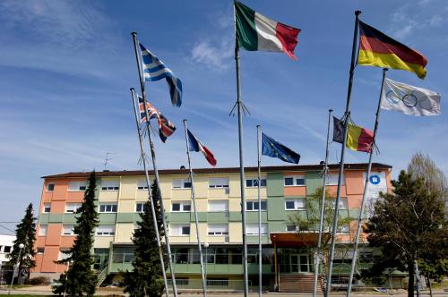 a group of flags in front of a building at ETHIC ETAPES DIJON Accueil 24h24 et parking gratuit in Dijon