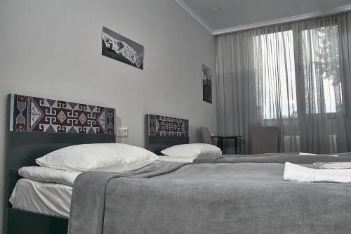 Un ou plusieurs lits dans un hébergement de l'établissement Guesthouse of Manoni Ratiani