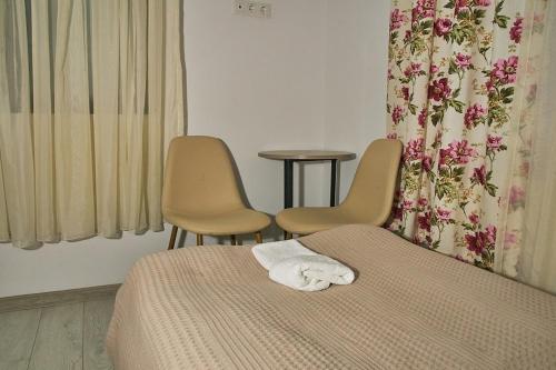 Un ou plusieurs lits dans un hébergement de l'établissement Guesthouse of Manoni Ratiani