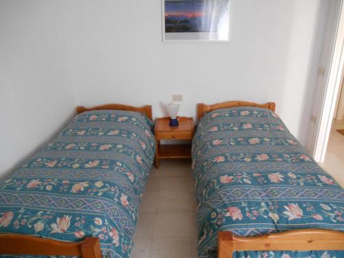 two beds sitting next to each other in a room at Chalet Migazzi in Cogolo
