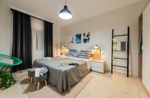 a bedroom with a bed and a table in it at Nordik Rooms Urban - Trinidad "Copenhague" in Málaga