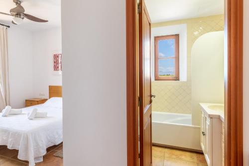 a bedroom with a bed and a tub and a sink at Son Mesquida d'Abaix in Algaida