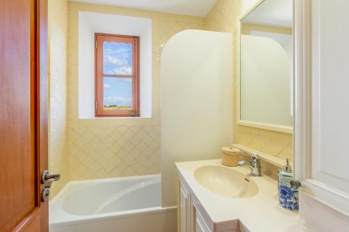 a bathroom with a sink and a tub and a mirror at Son Mesquida d'Abaix in Algaida