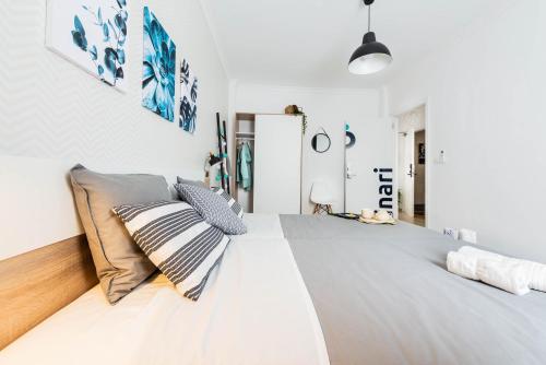 a bedroom with a large white bed with pillows at Nordik Rooms Urban - Trinidad "Copenhague" in Málaga