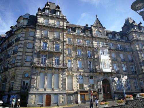 a large building on the corner of a street at Studio Résidence le Metropole in La Bourboule