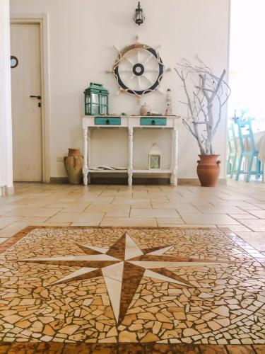 a room with a table and a star on the floor at B&B La Rosa dei Venti in Ginosa Marina