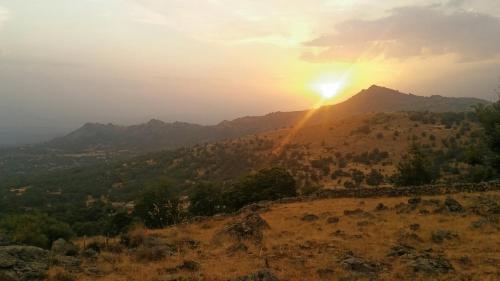 a view of the sun setting on a mountain at La Covatilla III in La Hoya