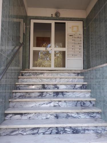 a set of stairs in a room with a window at Rio de Mouro Quartos in Sintra