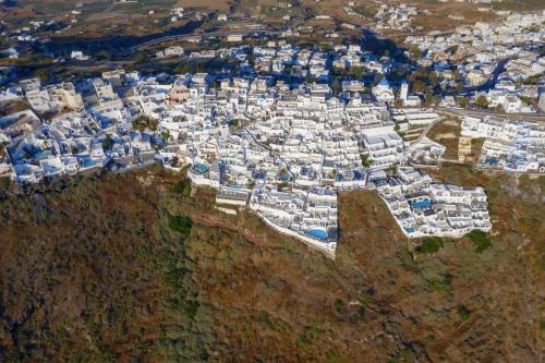 an aerial view of a town on the side of a mountain at Mirabo Villas in Firostefani
