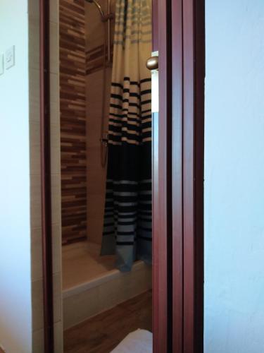 a closet with a sliding glass door with clothes in it at Soba Željka in Bribir