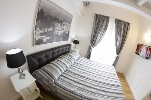 a bedroom with a large bed and a window at B&B Lame 57 in Bologna