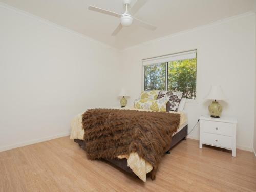 a bedroom with a bed and a window at Coolum Street 41 Dicky Beach in Caloundra