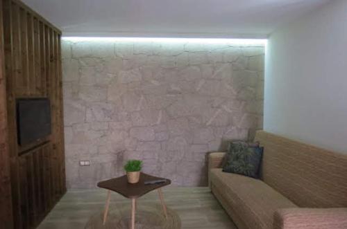 a living room with a couch and a table at A Casinha da Padaria, Soajo in Soajo
