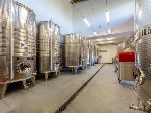 a row of silver tanks in a brewery at Agriturismo Il Sapore Della Luna in Monteprandone