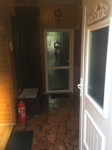 a door leading into a room with a glass door at Apartman-Donau Tát in Tát