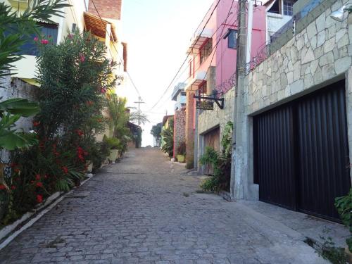 an empty alley way with buildings and a gate at Marlymar Apart Pousada in Natal