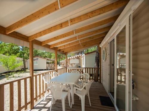 a patio with a table and chairs on a deck at Camping Village Mugello Verde in San Piero a Sieve