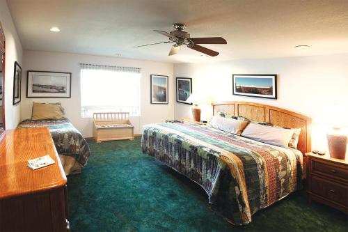 a bedroom with two beds and a ceiling fan at Suite 2 Lynn View Lodge in Haines