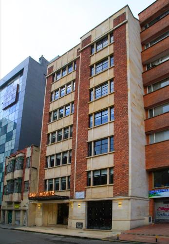 a large brick building on the corner of a street at Hotel Museo San Moritz in Bogotá