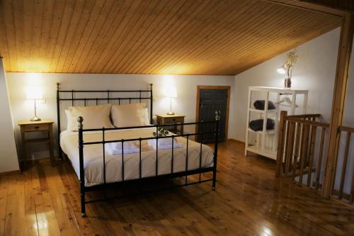 a bedroom with a bed with two night stands and two lamps at Nature Rural- Collections in Berzosa del Lozoya