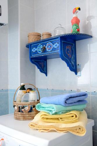 a bathroom with towels and a basket on top of a toilet at Ciassa Noeva in Pieve di Teco