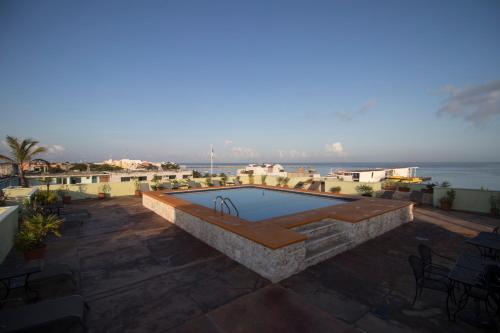 a swimming pool on the roof of a building at Hotel Plaza Cozumel in Cozumel