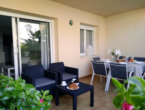 a patio with a table and chairs and a table and a table and chairsktop at Stil Mar Anna Terra - by Apartamentos Stil Mar Anna in L'Escala