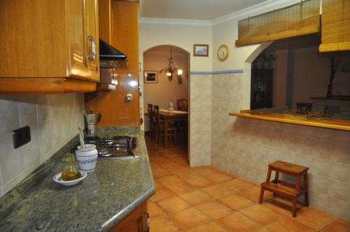 a kitchen with a counter and a stove top oven at Corral de Jaume in Àger