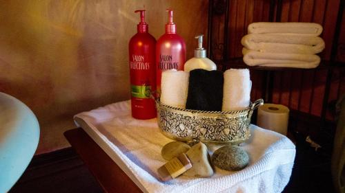 a bathroom table with a candle holder and bottles of wine at MaMere's Guest House in Monmouth