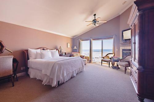 a bedroom with a bed and a view of the ocean at On the Beach Bed and Breakfast in Cayucos