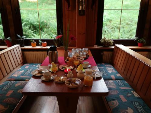 a table with food on it in a room with windows at Gasthaus&Pension "Grünes Herz" in Unterschönau