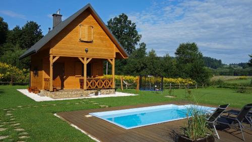 a small house with a pool in the yard at Domek Skowronek z basenem in Lesko
