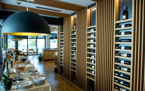 a dining room with a table and a wine cellar at City Inn in Pristina
