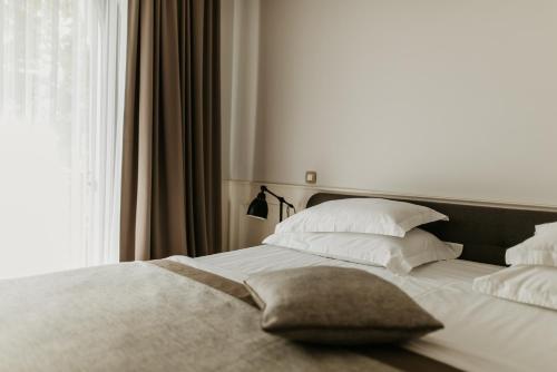 Postel nebo postele na pokoji v ubytování Hotel Majestic