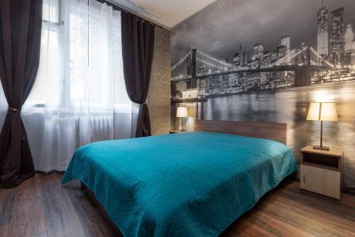 a bedroom with a blue bed and a window at VITOSHKA Pleasure place in Sofia
