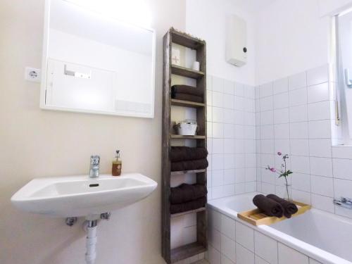 a bathroom with a sink and a tub and a towel rack at hoamelig in Batschuns