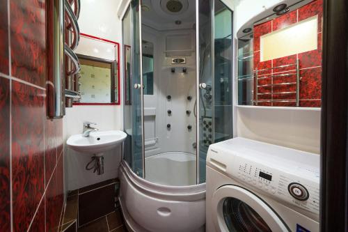 a bathroom with a washing machine and a sink at Flat on Dneprovsky boulevard in Mogilev
