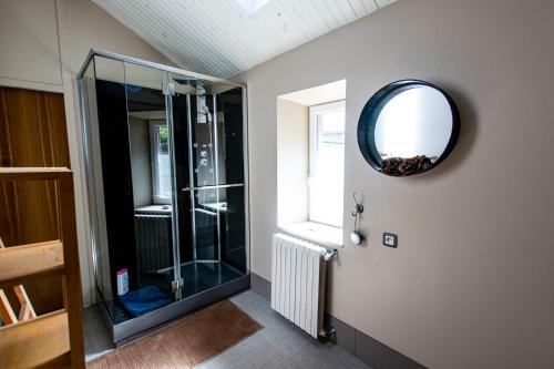 a bathroom with a shower and a mirror on the wall at Les Trois Fontaines in Poitiers