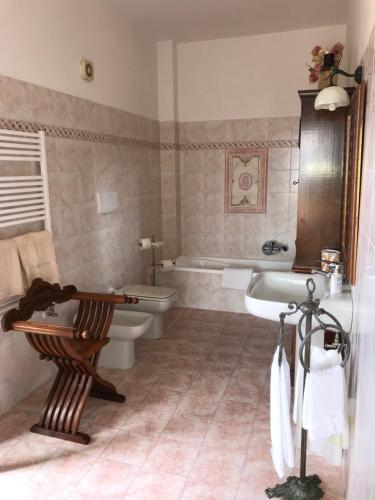 a bathroom with a tub and a toilet and a sink at Relais Le Folaghe in Ladispoli