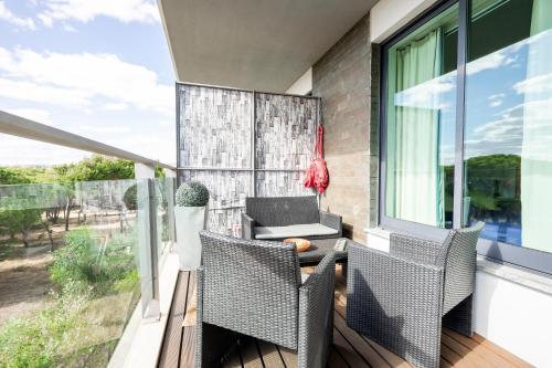 a patio with a table and chairs on a balcony at Golf Residence Apartment in Vilamoura
