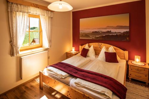 a bedroom with a large bed and a window at Familienweingut Oberer Germuth in Leutschach