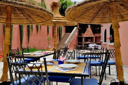 a restaurant with tables and chairs and umbrellas at LHOSTEL à Casablanca in Casablanca