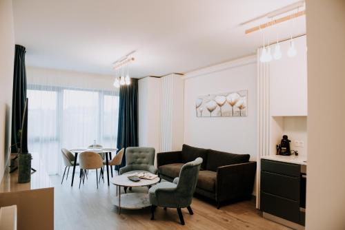 a living room with a couch and a table at ZEN Central Apartments in Cluj-Napoca