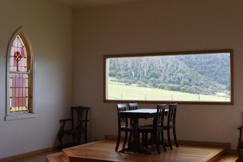 a dining room with a table and chairs and a window at Seacroft Estate in Apollo Bay