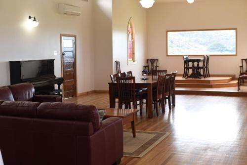 a living room with a couch and a table and chairs at Seacroft Estate in Apollo Bay