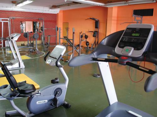 a fitness room with a gym with a treadmill at Holiday Park CFK in Vrbas