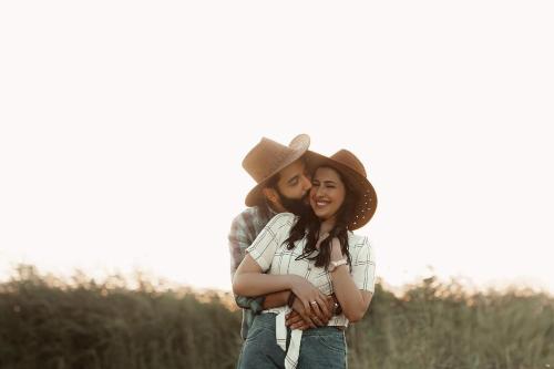 a couple hugging in a field with a cowboy hat at Tunis Village Chalet in Fayoum Center