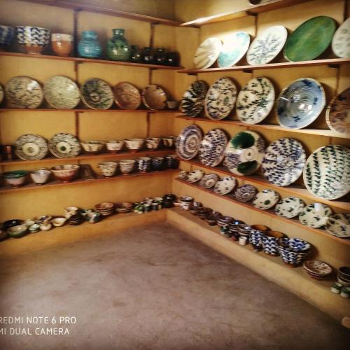 a room filled with shelves filled with pottery at Tunis Village Chalet in Fayoum Center