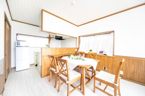 a kitchen and dining room with a table and chairs at Awaji Seaside Resort in Iwaya 3000 in Awaji
